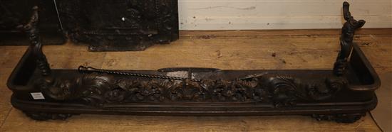 A Victorian cast iron kerb, with scrolled acanthus front, together with attached fire dogs, and three irons (4)